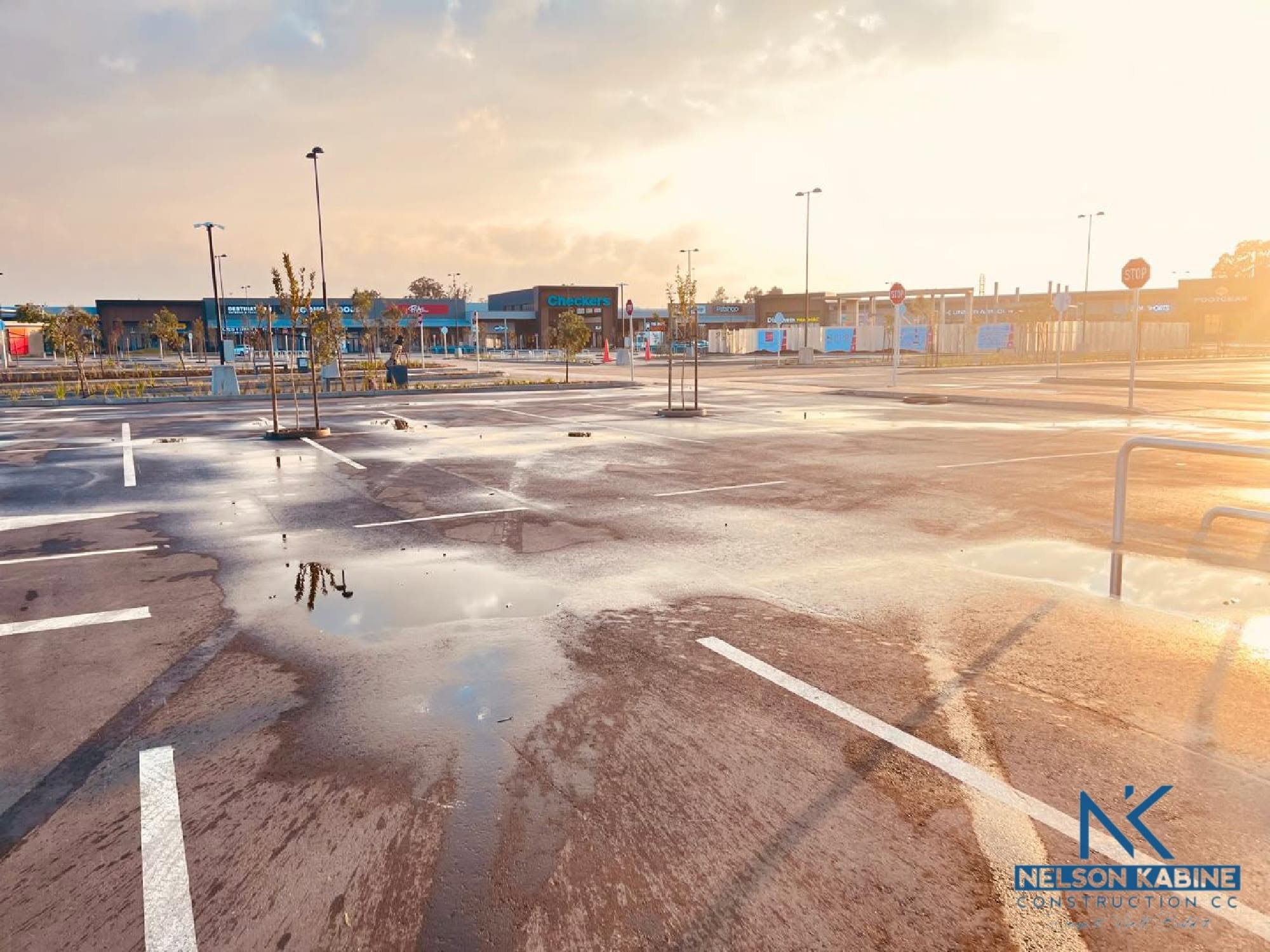 Completed shopping centre and parking area at sunset