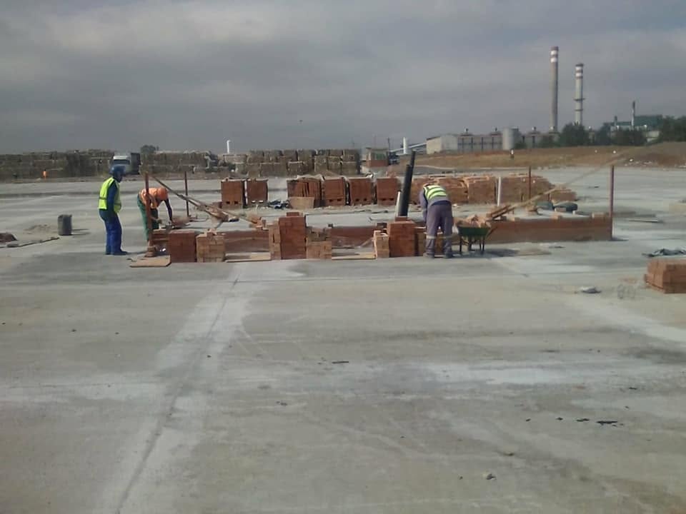 Bricklayers completing a boundary wall