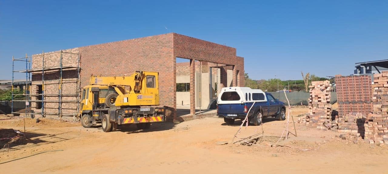 Face-brick unit nearing completion with crane on site