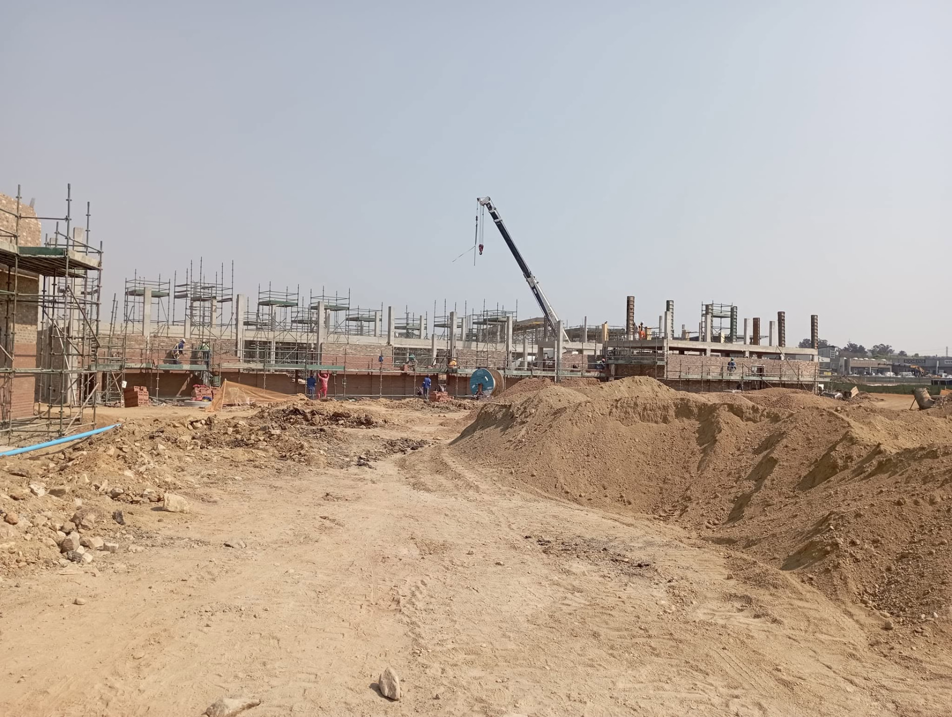 Wide view of a large retail development under construction