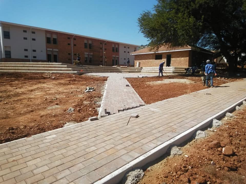 Team plastering the exterior walls of a house